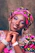 A vibrant photo of a smiling young woman wearing colorful, funky clothing from stay funky fashion.