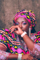 Model wearing a Kente print blouse paired with urban streetwear accessories.