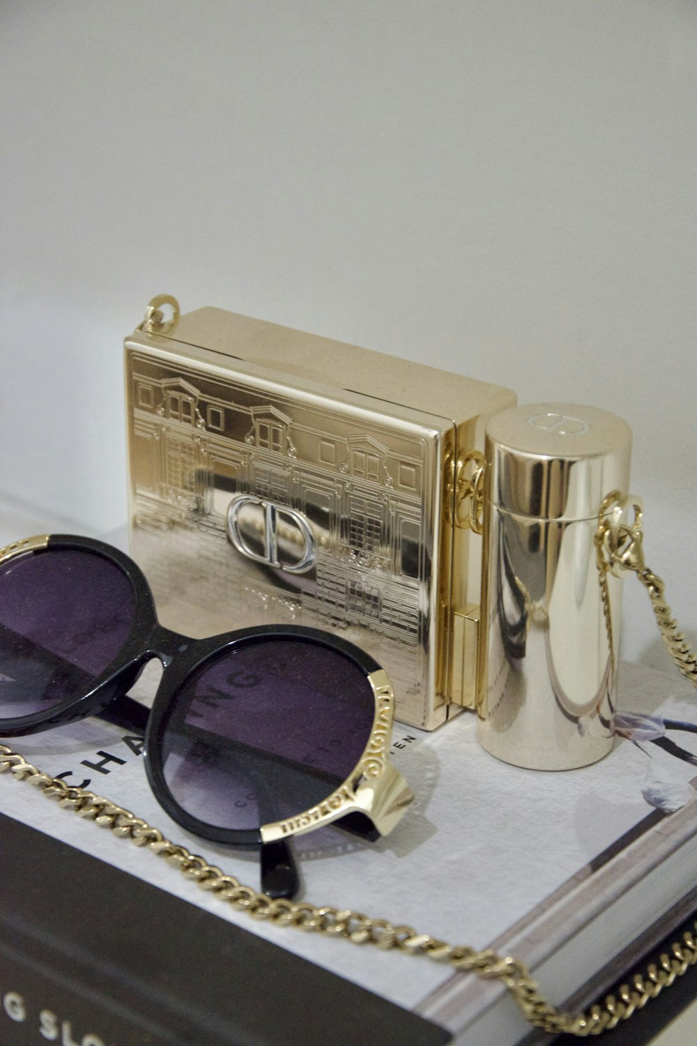 a gold jewelry box with a silver chain and a gold chain