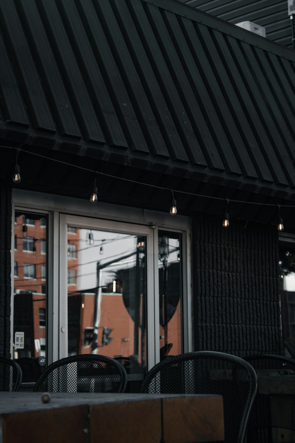 a table and chairs under a black awning