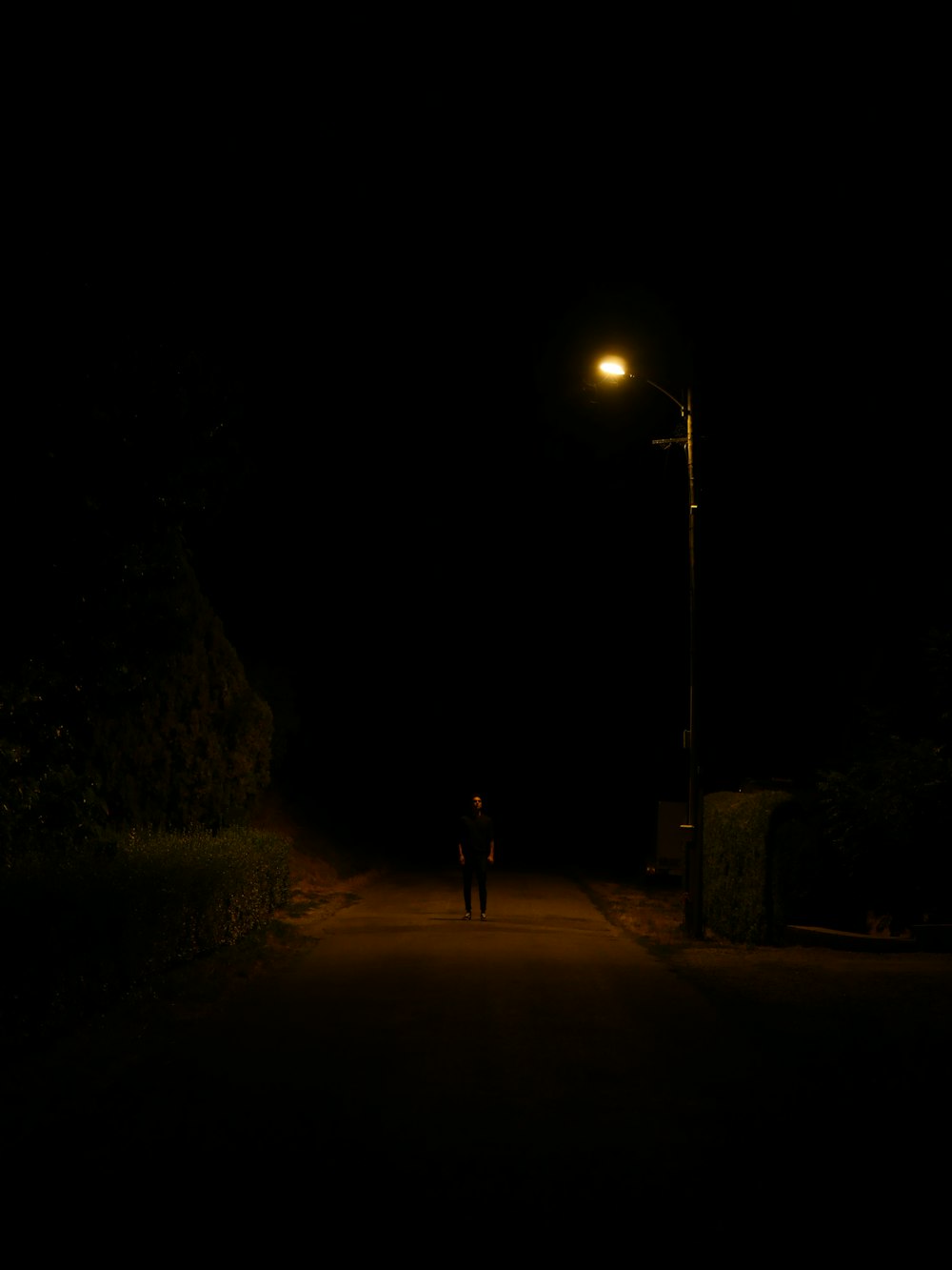 a person walking down a street at night