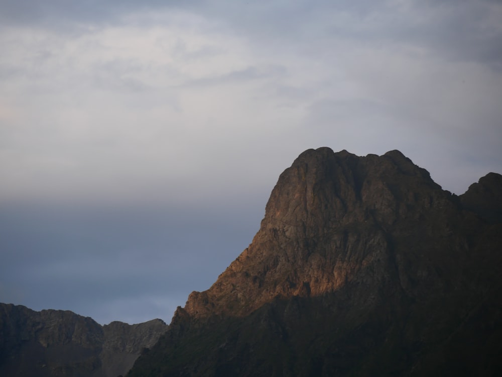 a mountain with clouds above it