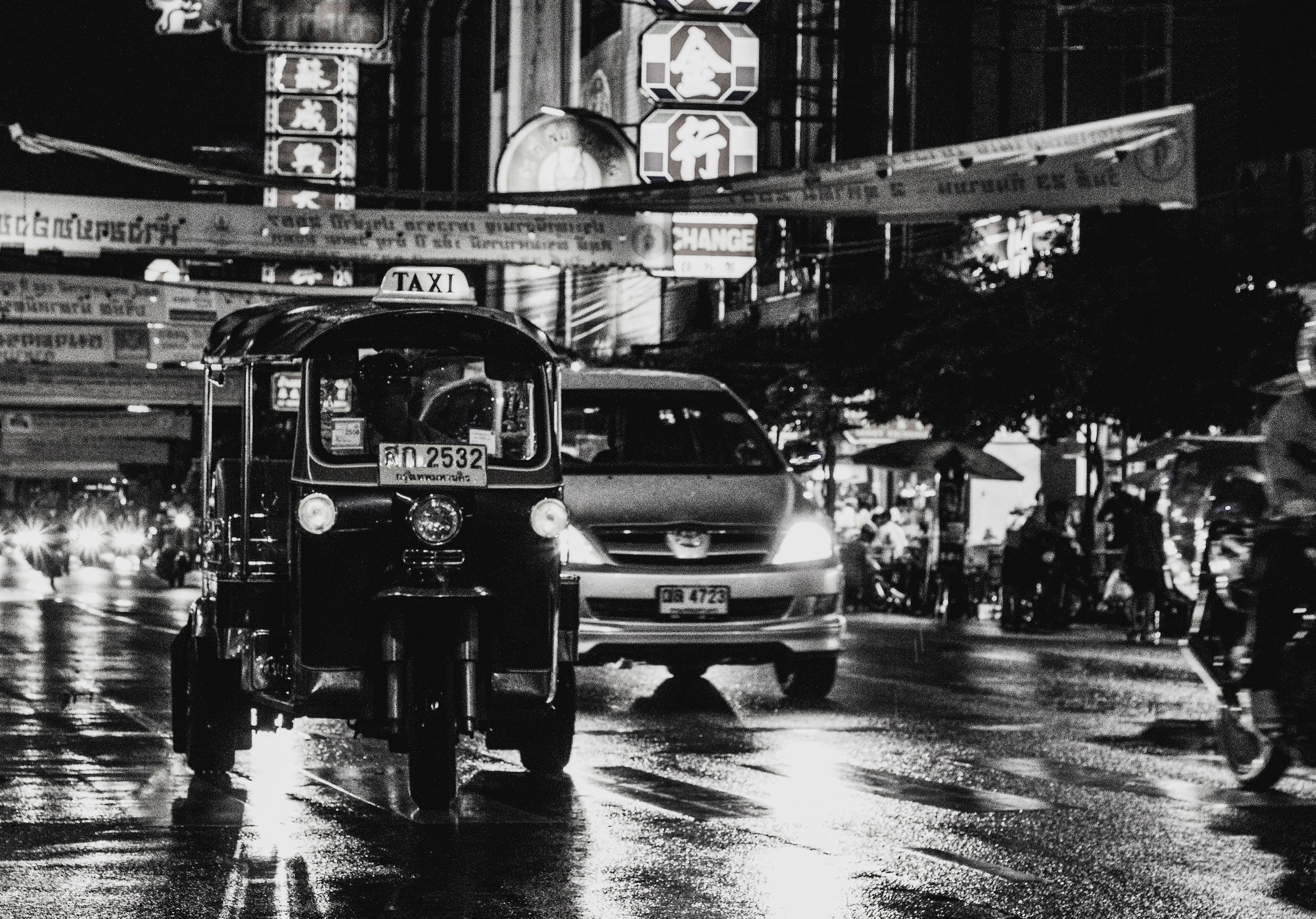 a couple of cars on a wet street
