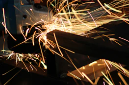 Sparks flying as the core cutting machine slices through thick wood, captured in ultra HD.