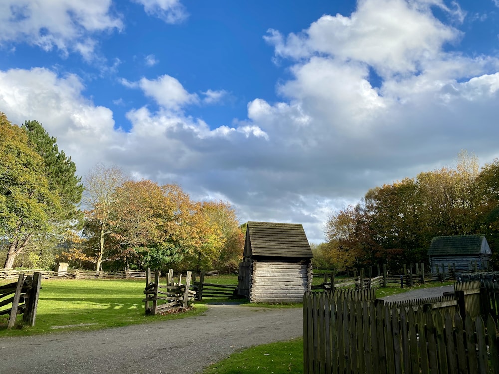 a wooden fence and a small building