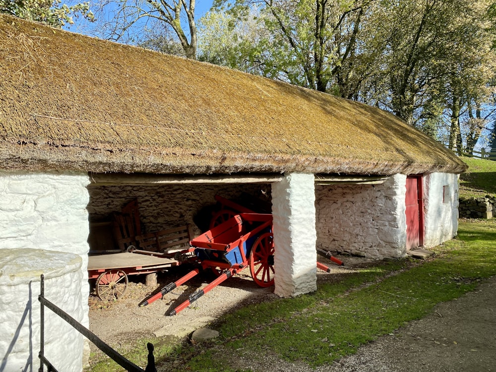 a small building with a wagon in front of it