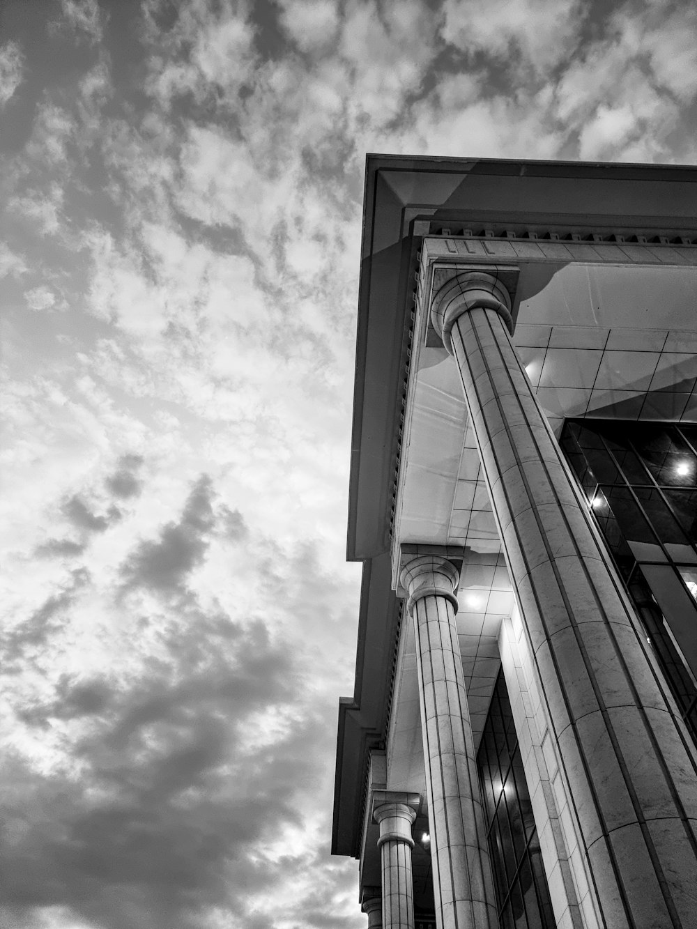 a tall building with a cloudy sky