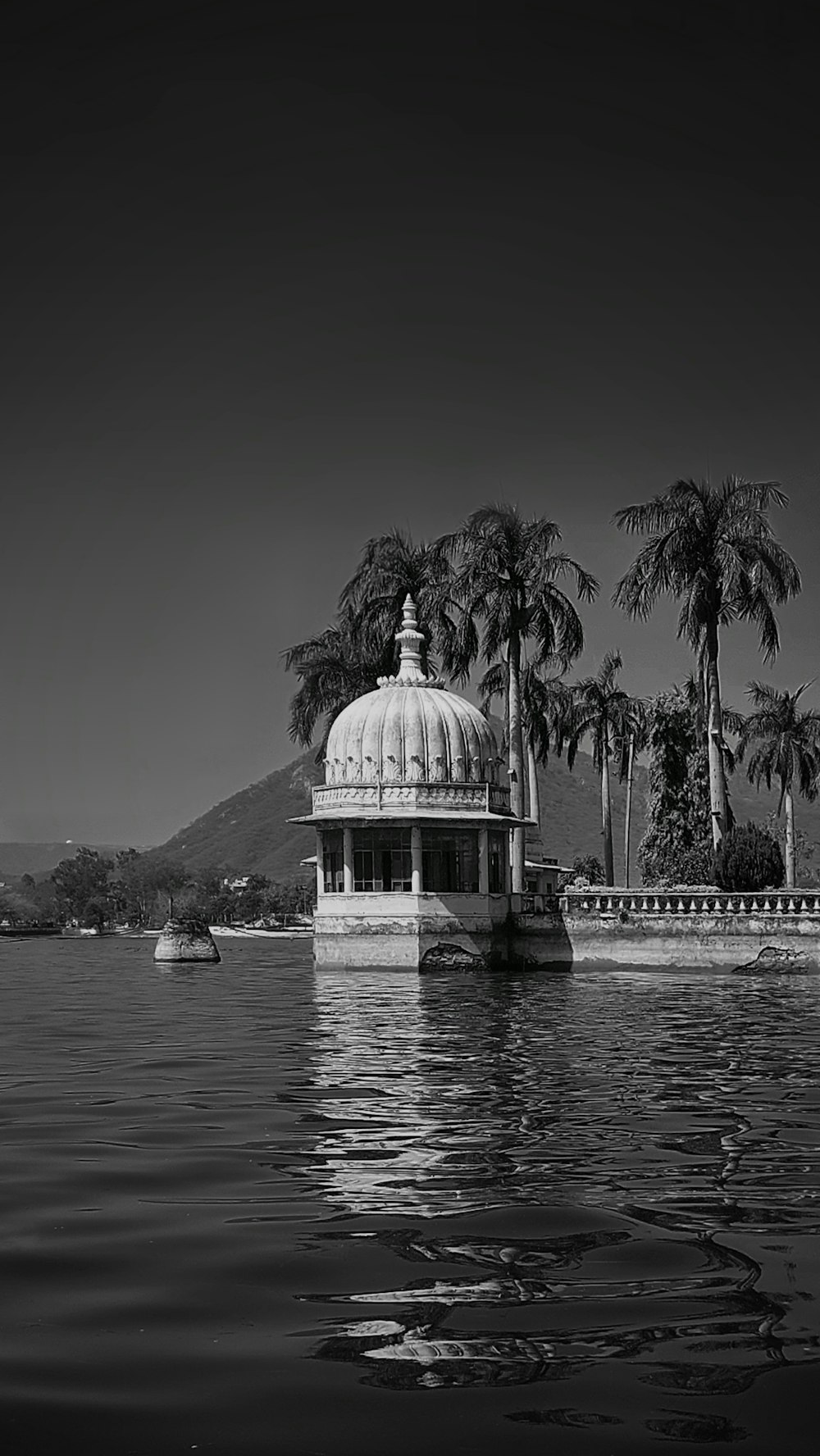 a building with a dome on top surrounded by water