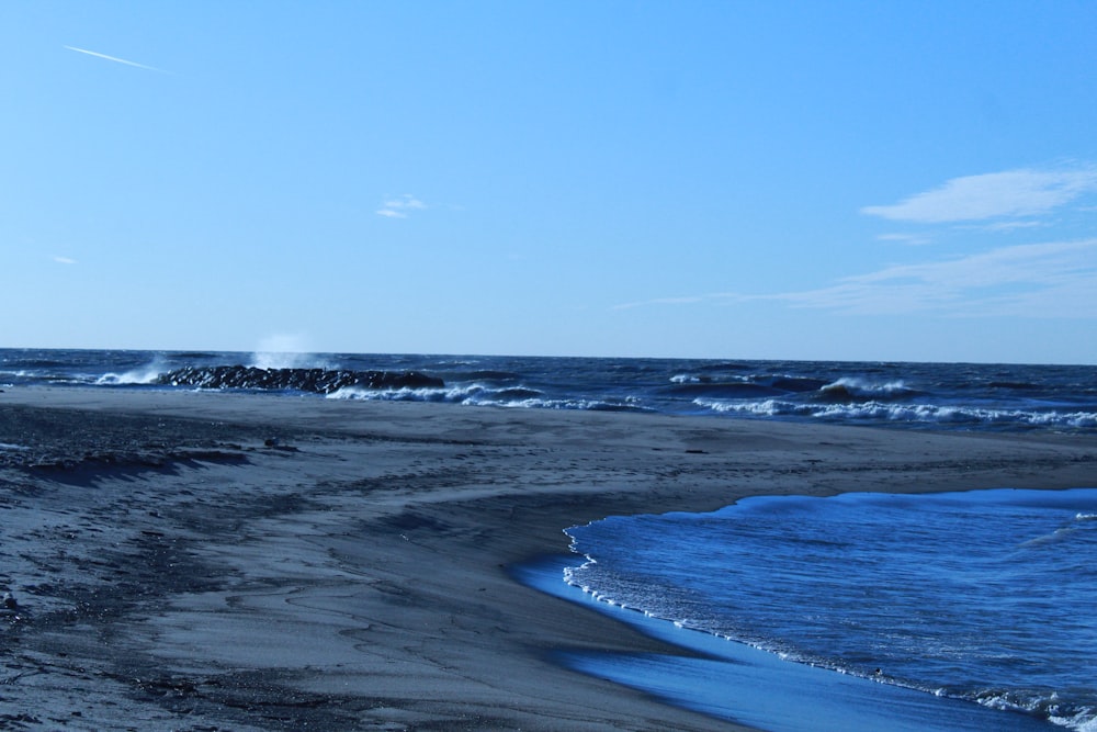 a beach with waves crashing on it