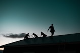 A team of inspectors working together on a rooftop.