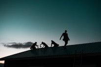 A team of roofers collaborating on a project, showcasing teamwork and expertise in a construction setting.
