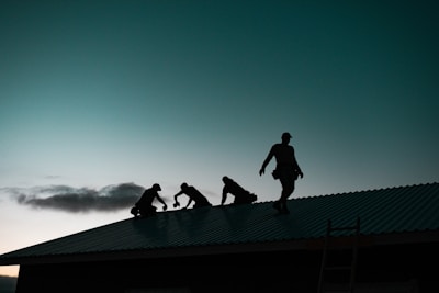 A team of inspectors working together on a rooftop.