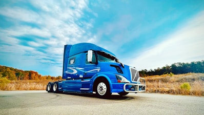a blue truck on a road