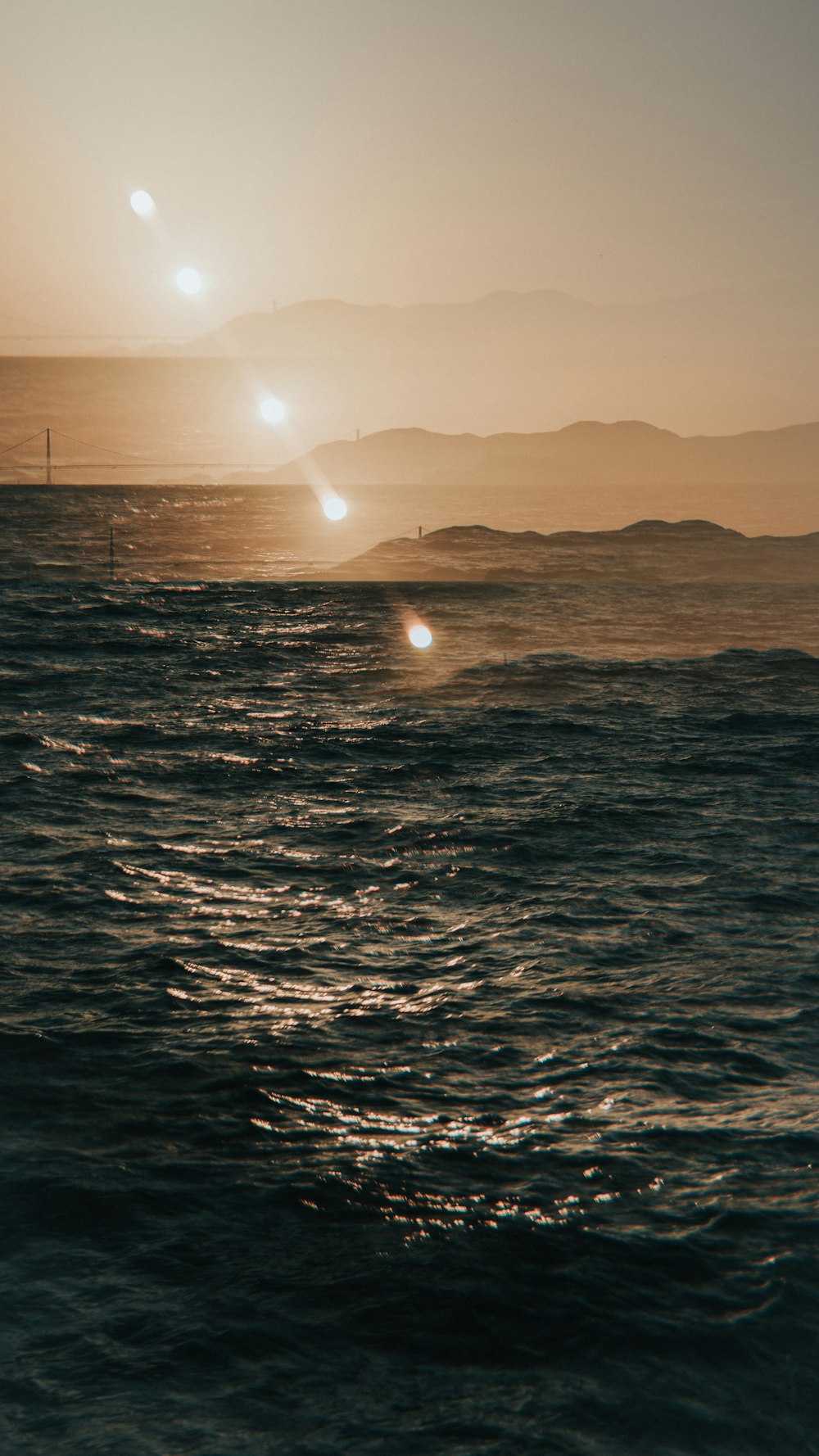 a body of water with a sunset in the background