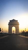 India Gate war memorial with surrounding green gardens in New Delhi