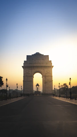 India Gate war memorial with surrounding green gardens in New Delhi