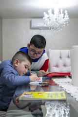 a man and a boy playing a board game on a table