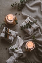 a candle and a plant on the ground