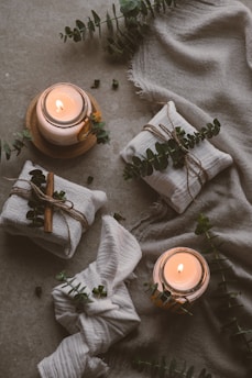a candle and a plant on the ground