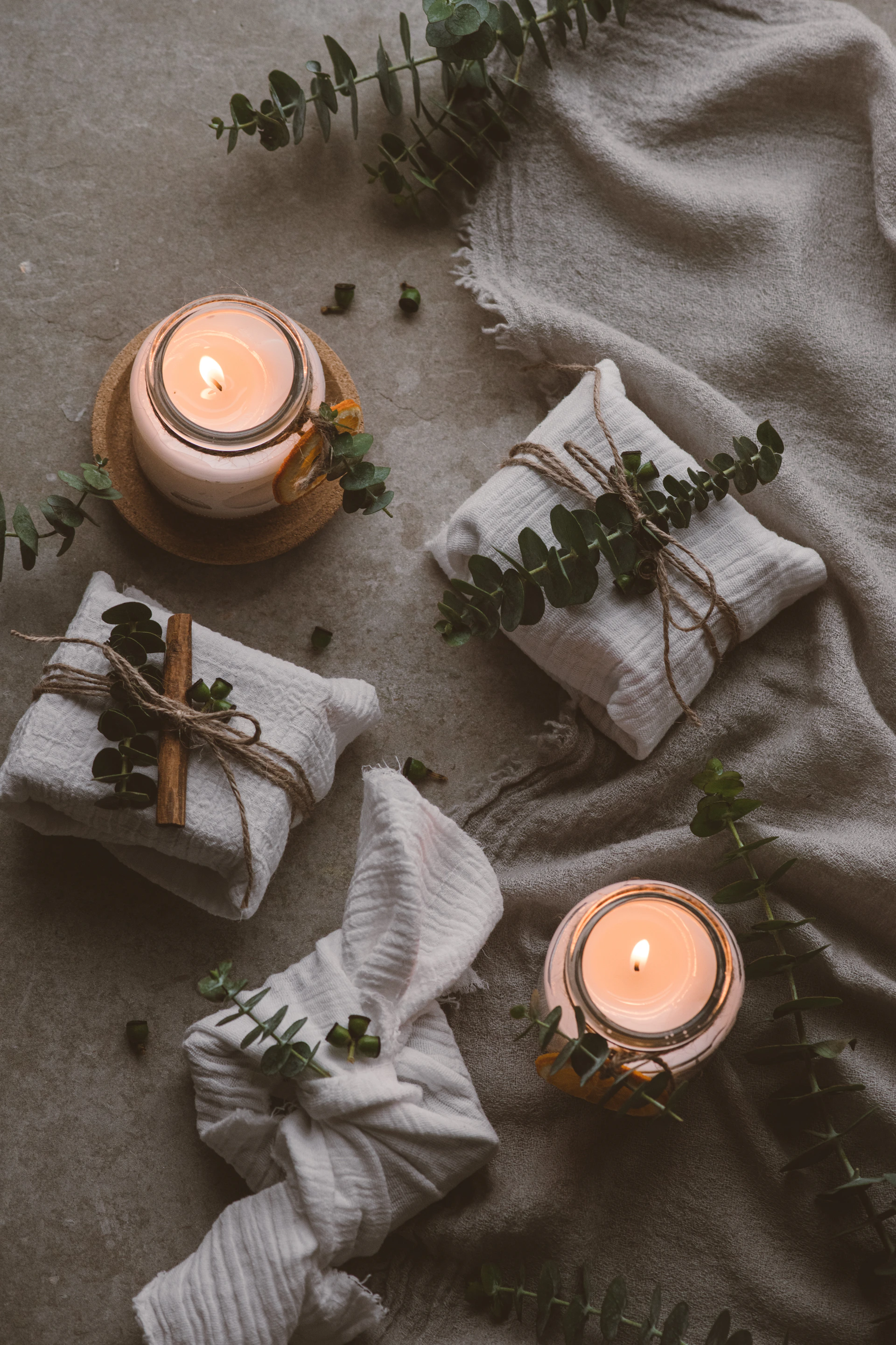 a candle and a plant on the ground