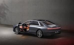 A sleek, modern driving school car parked in an urban setting with clean lines and soft natural light.