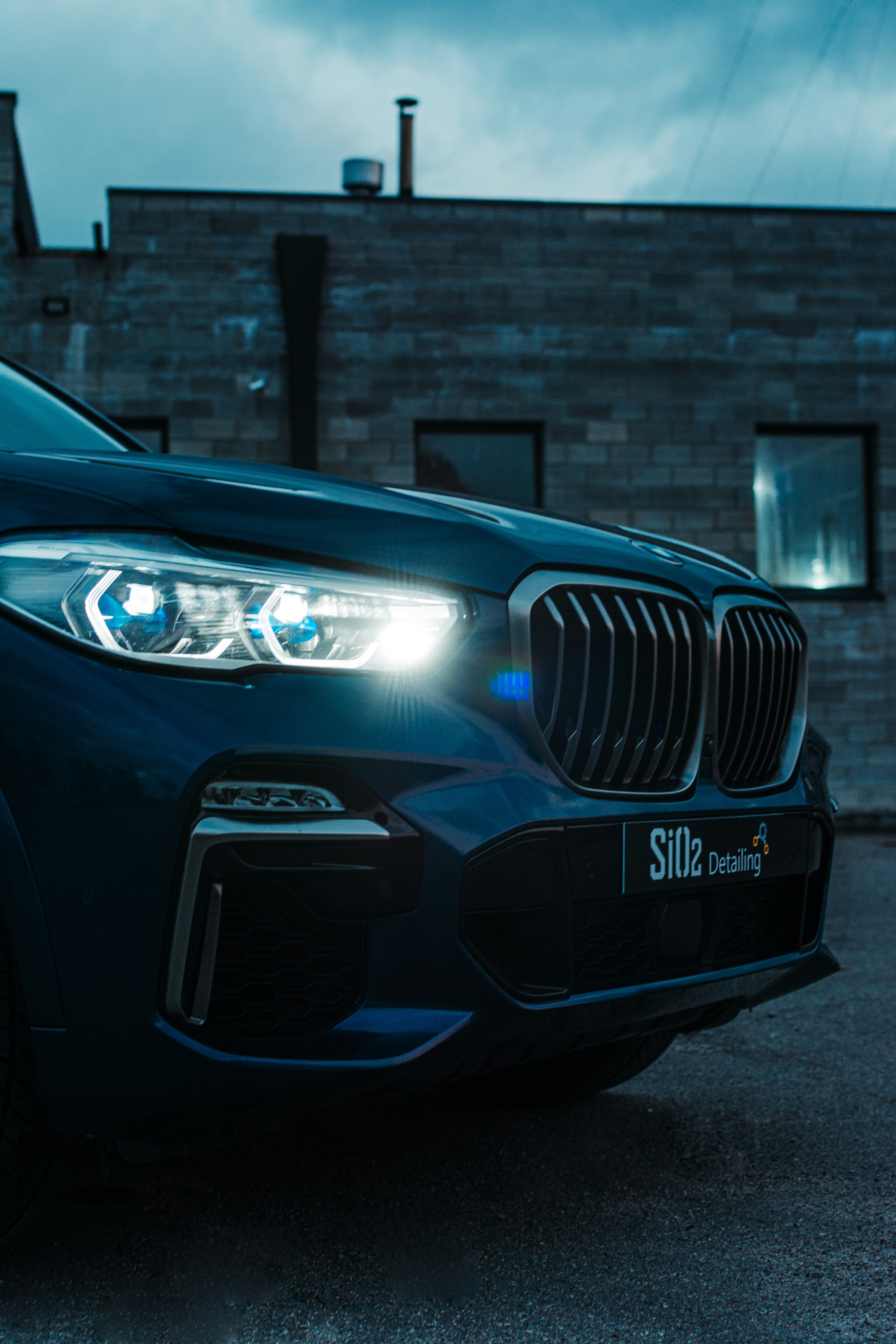 a car parked in front of a brick building