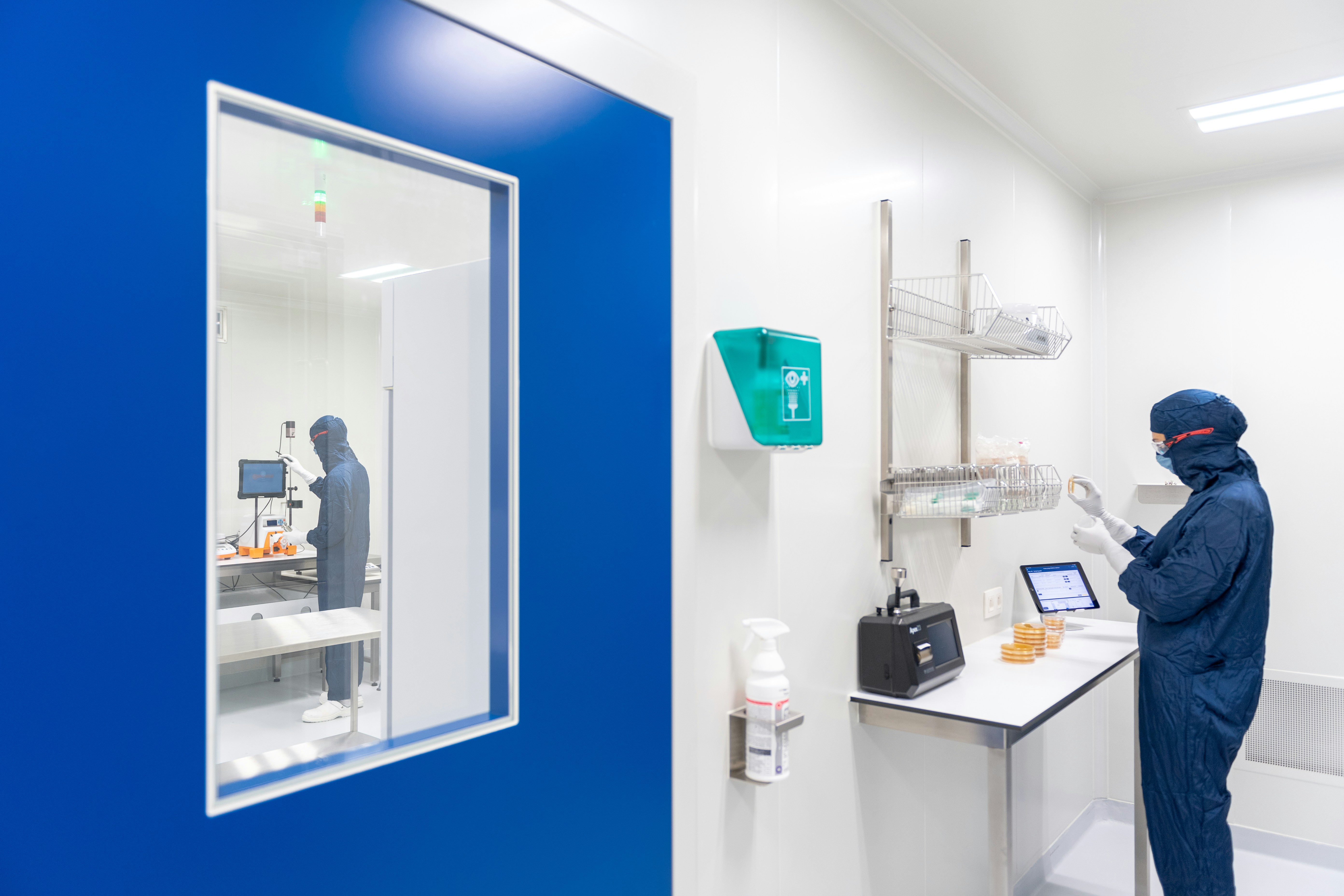 Cleanroom technician inspecting wide field instrument optical bench assembly