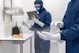 a couple of people wearing gloves and masks and gloves
