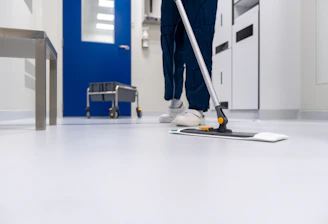 Cleaning crew efficiently sanitizing a modern commercial office space with attention to detail.