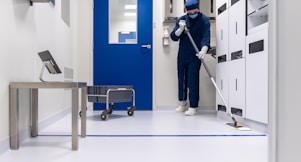 a person in a blue mask and a mask holding a ladder