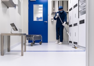 a person in a blue mask and a mask holding a ladder