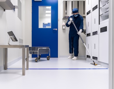 a person in a blue mask and a mask holding a ladder