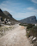 A dusty path leads through rocky, mountainous terrain at Reubens Choice Karoo.