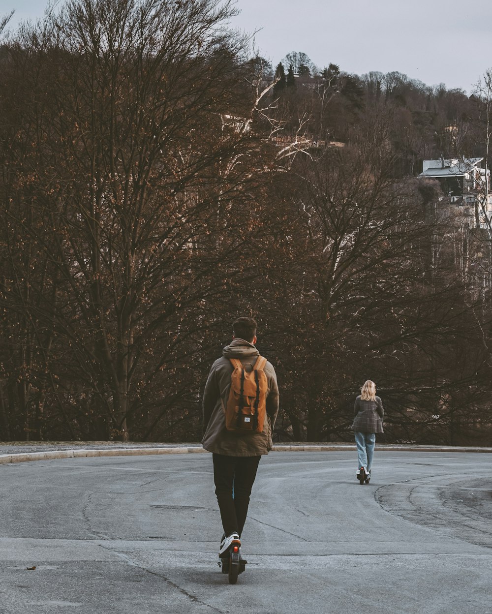 a man and a woman rollerblading on a road