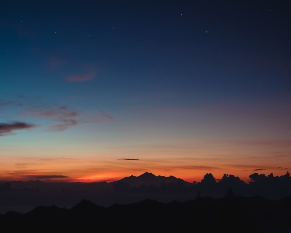 a sunset over a mountain range