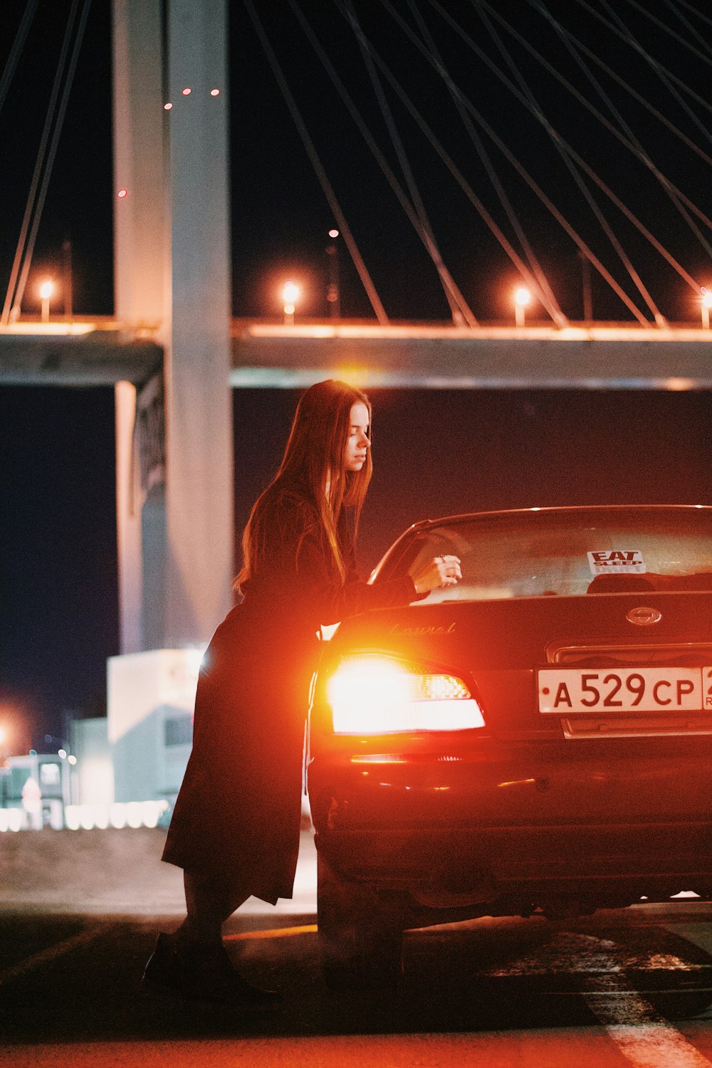 a person standing next to a car