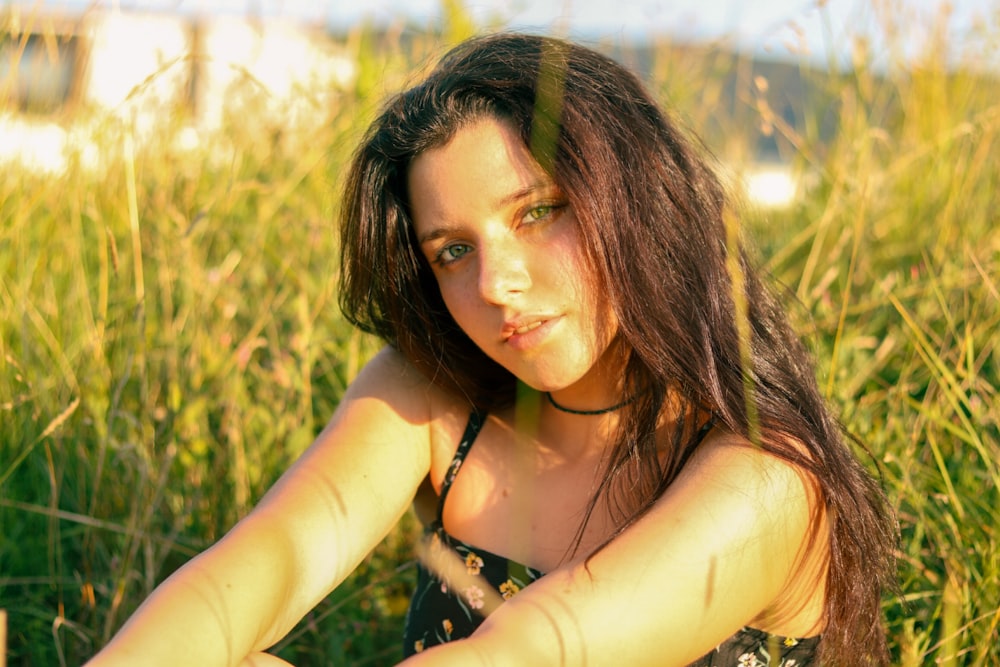 a woman with long hair in a field