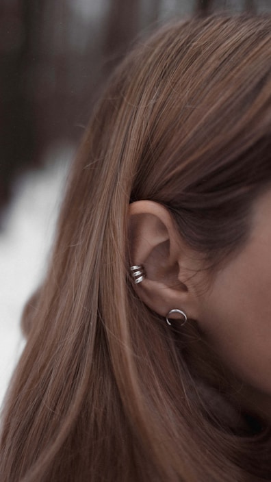 a woman with her hand on her ear