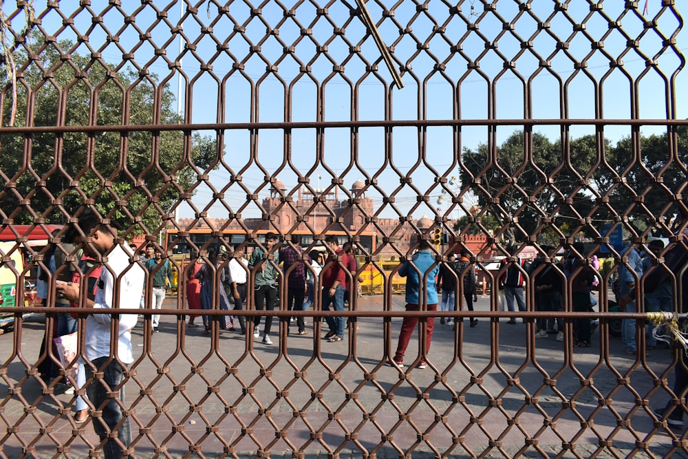 a group of people in a fenced in area