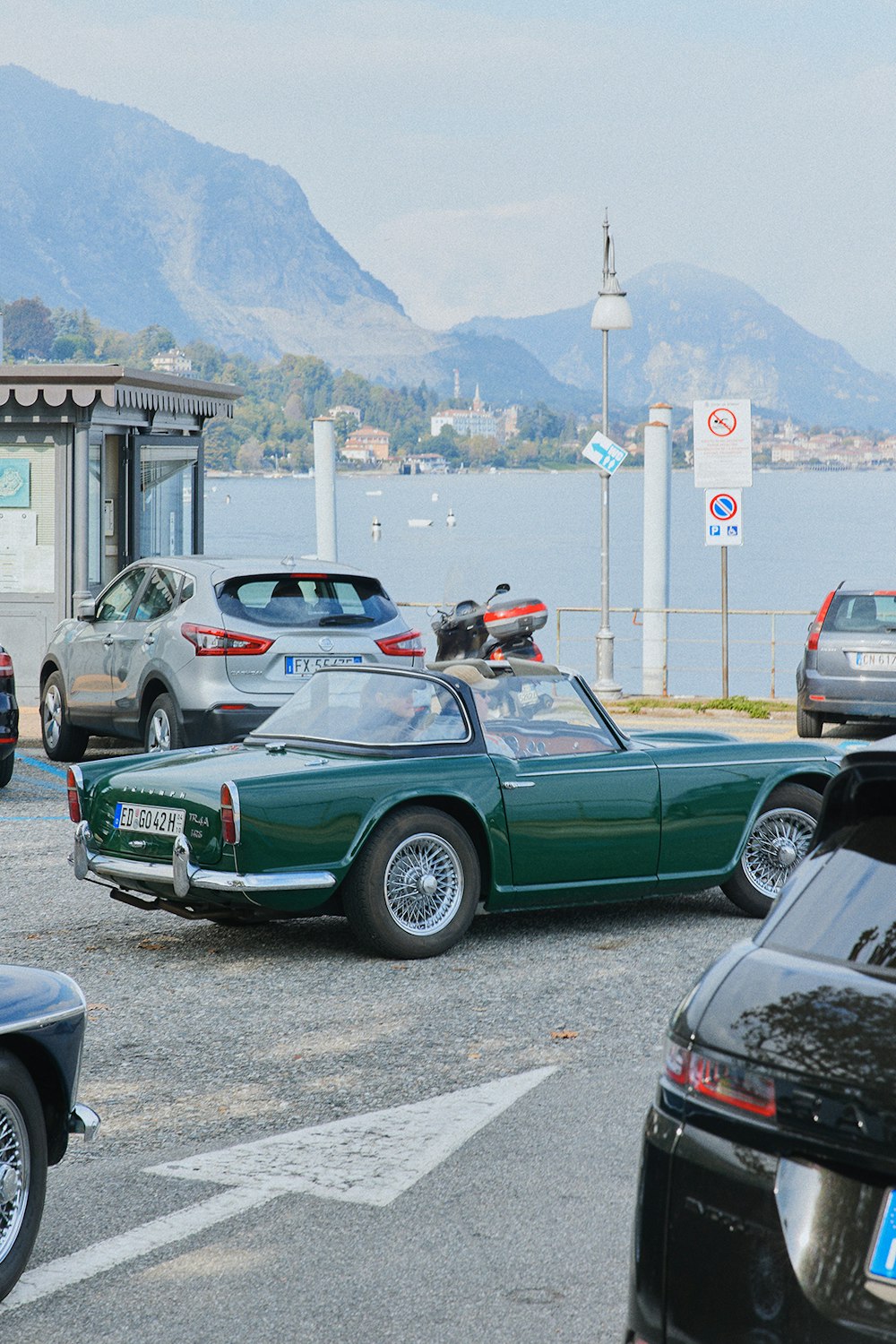 a group of cars parked by a body of water