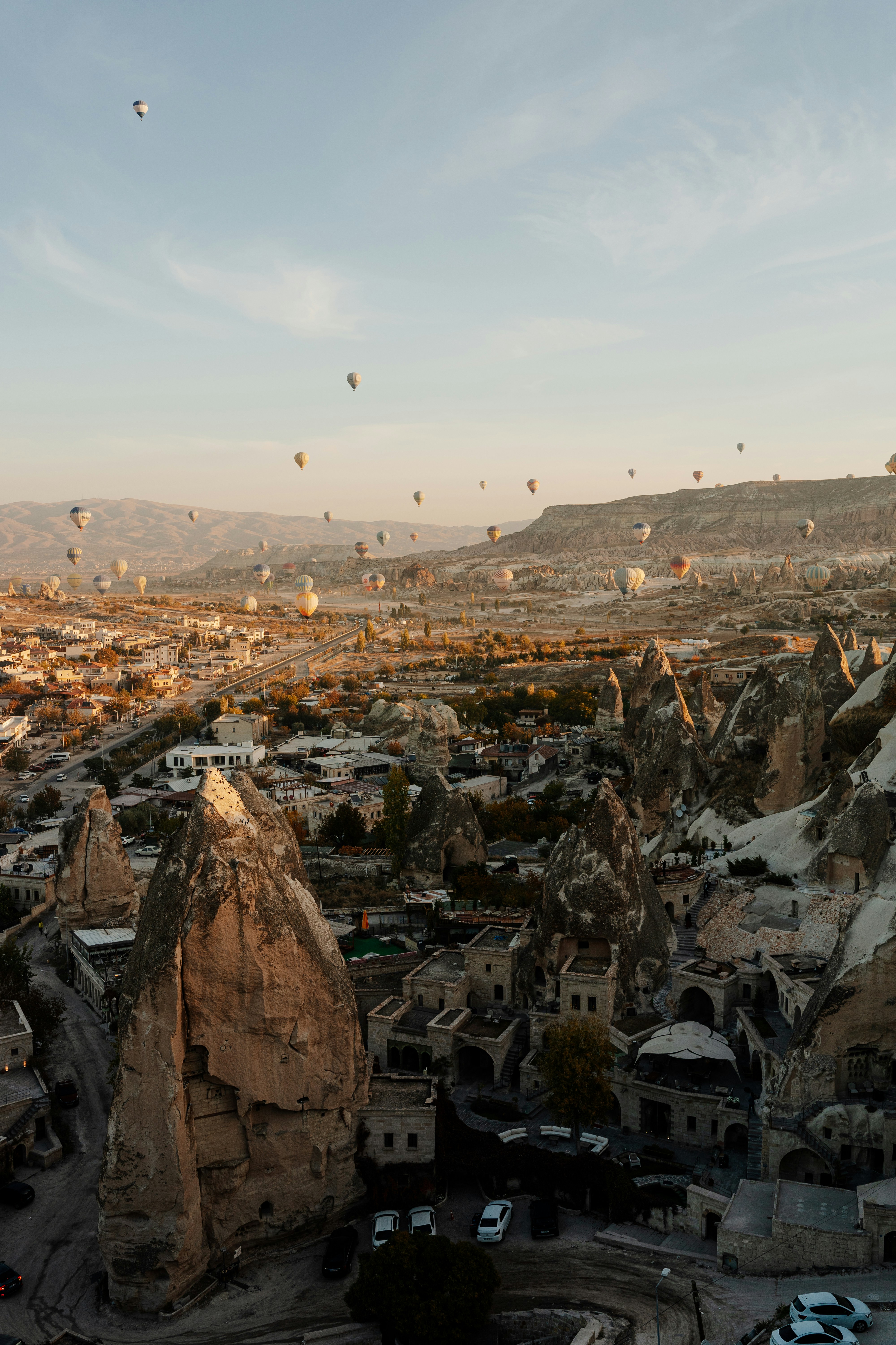 A group of hot air balloons in the sky over a city photo – Free ...