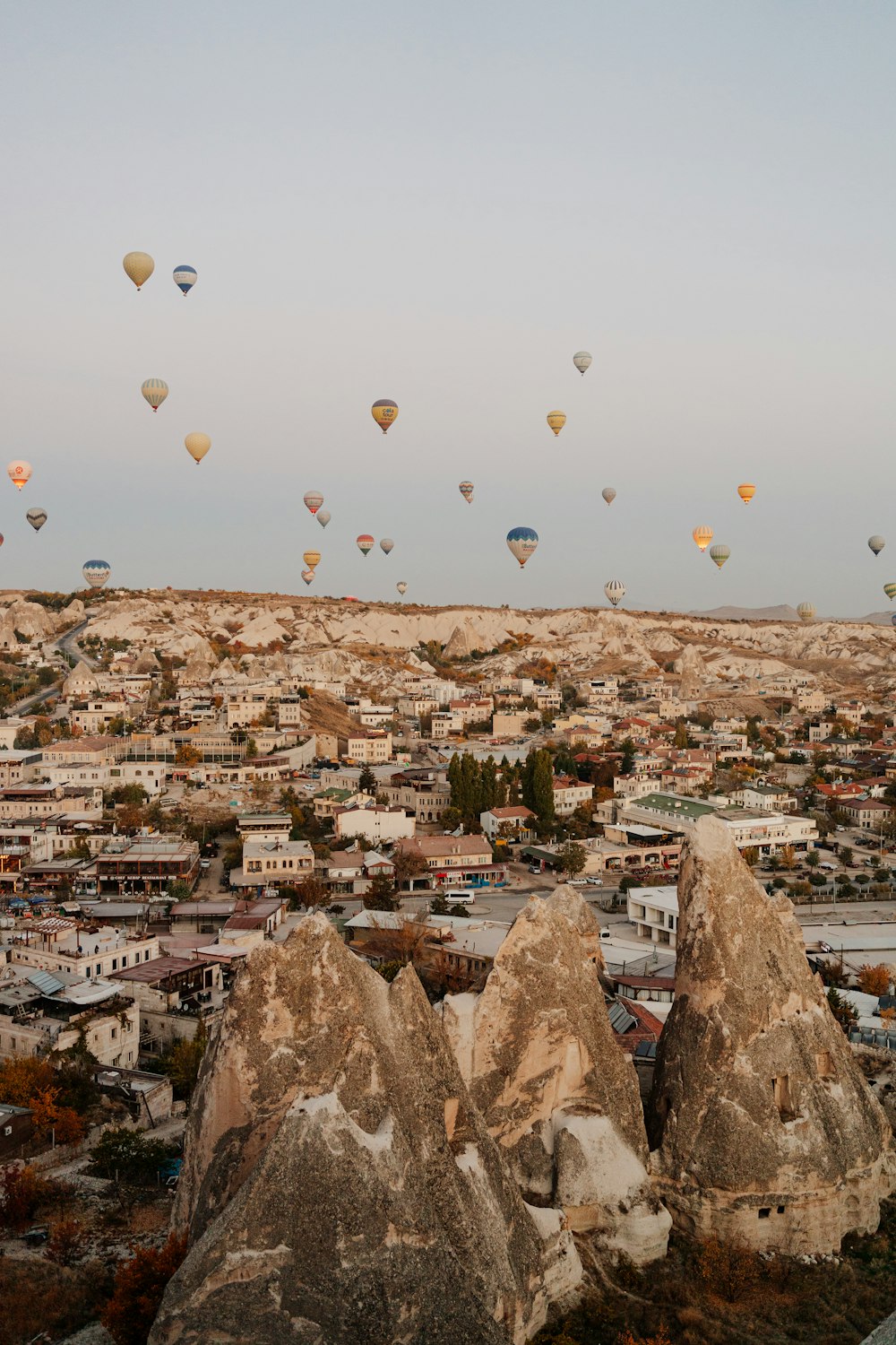 a group of hot air balloons over a city