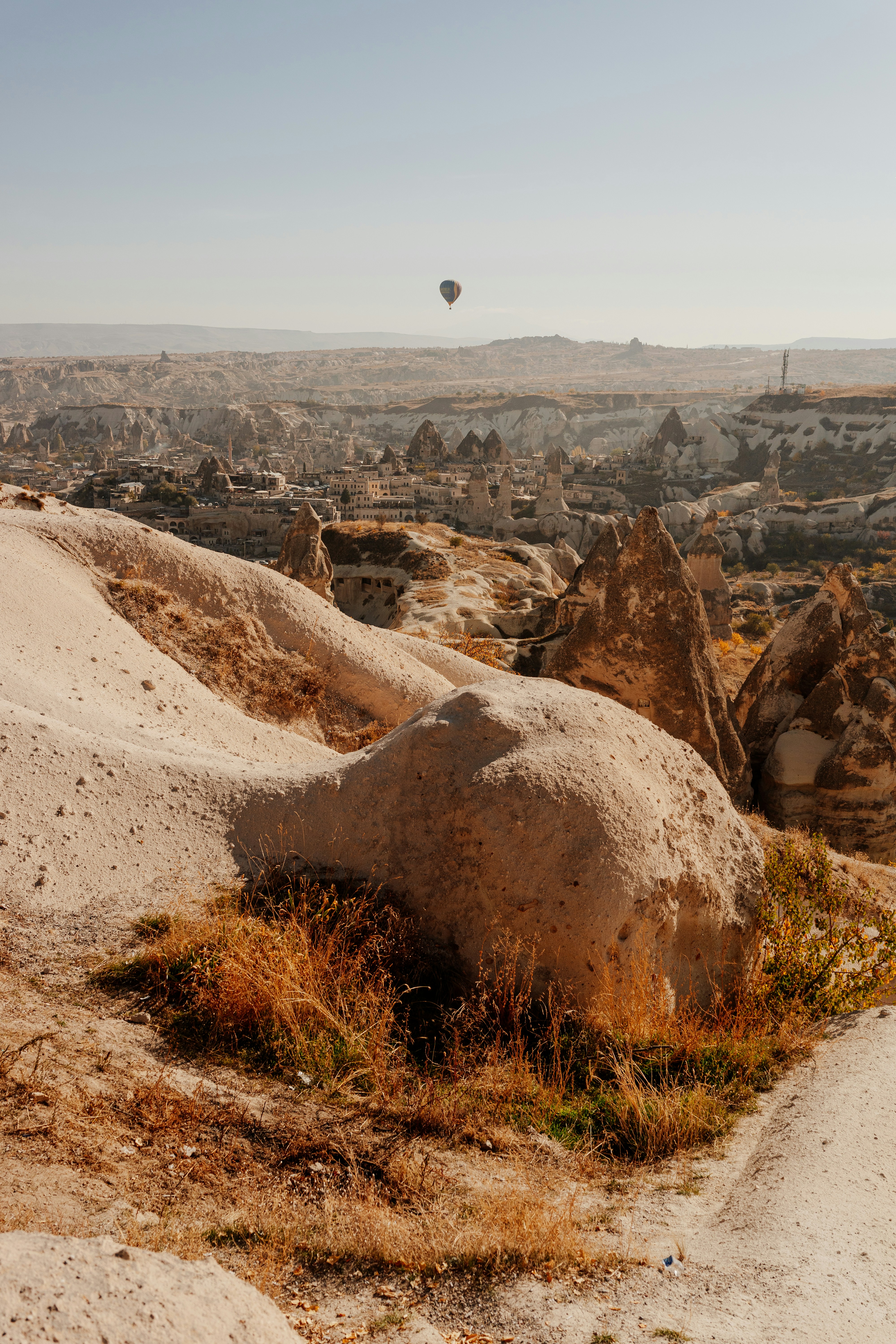 a hot air balloon flying over a canyon