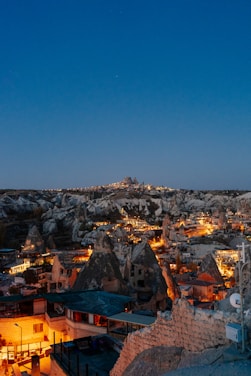 A stunning nighttime view of Neo Cappadocia's themed building illuminated with fantastic lights.