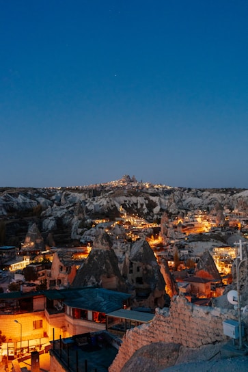 A stunning nighttime view of Neo Cappadocia's themed building illuminated with fantastic lights.