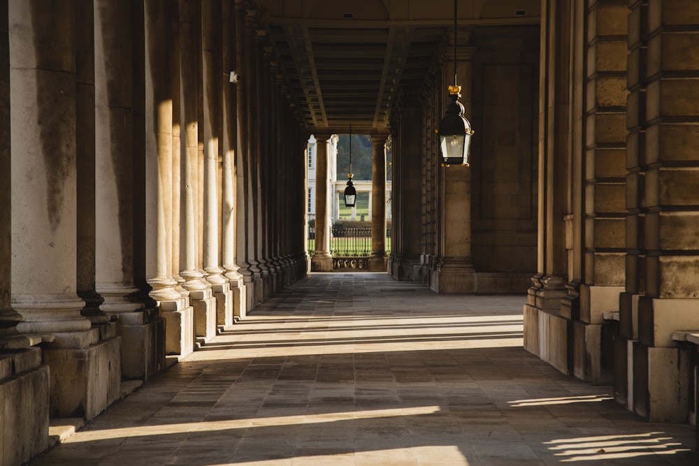 a hallway with columns and a gate