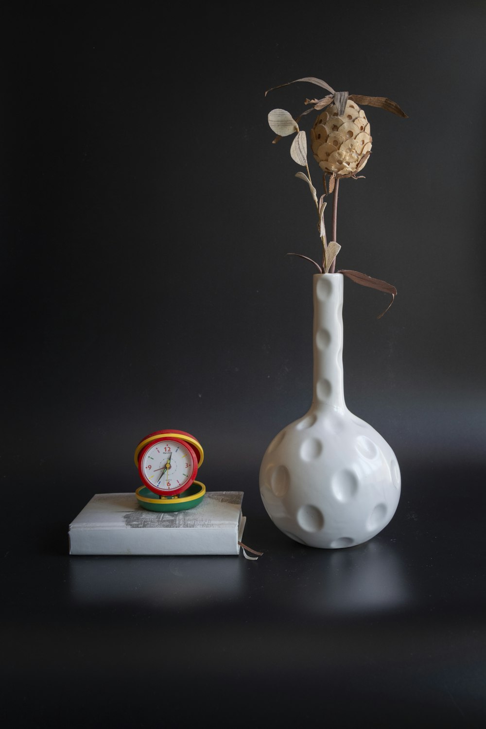 a clock and a vase with flowers