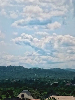 A panoramic view of rolling hills dotted with charming homes and winding roads.