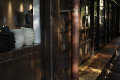 A set of biodegradable paper plates stacked neatly on a rustic wooden table with soft natural light.