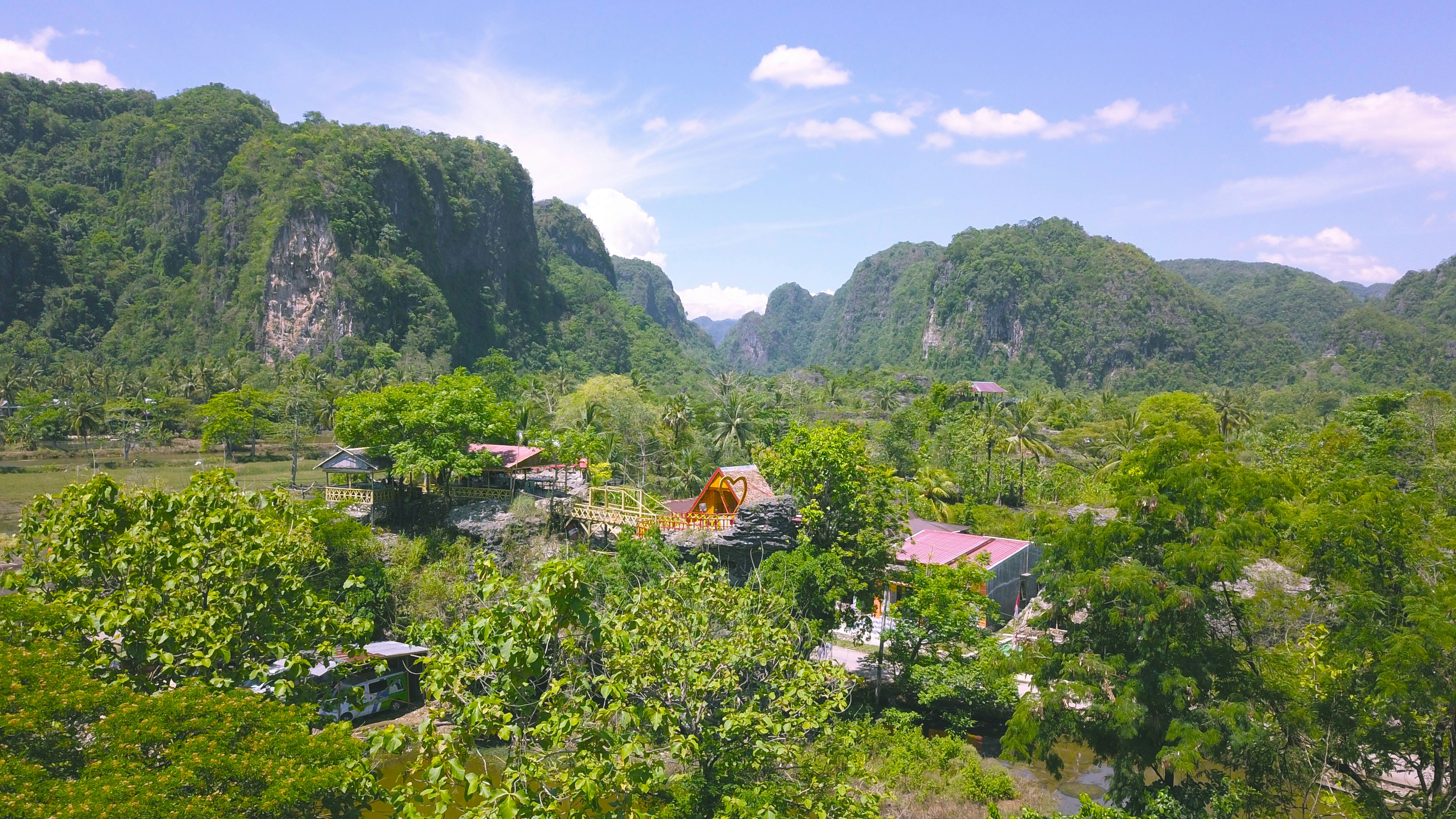 a group of houses in a valley, Rammang Rammang, Salenrang, Bontoa, Bontolemngan, Bontoa, Bontolemngan, Kec. Bontoa, Maros Regency, South Sulawesi
